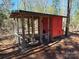 Red chicken coop with attached run in wooded area at 1627 Peden Bridge Rd, Chester, SC 29706