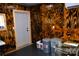 Storage room with wooden walls, bins and a dog cage at 1627 Peden Bridge Rd, Chester, SC 29706