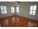 Spacious bedroom with hardwood floors and multiple windows at 5910 Trailwater Rd, Charlotte, NC 28278