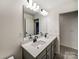Bathroom with double vanity, grey cabinets, and a large mirror at 14415 Autumncrest Rd # 2, Huntersville, NC 28078