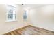Simple bedroom with hardwood floors and two large windows at 14415 Autumncrest Rd # 2, Huntersville, NC 28078