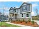Two-story house with gray siding, stone accents, landscaping, and a walkway at 14415 Autumncrest Rd # 2, Huntersville, NC 28078