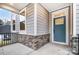 Front entry with a teal door, stone base, and a covered porch at 14415 Autumncrest Rd # 2, Huntersville, NC 28078