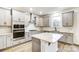 Modern kitchen with gray cabinets, granite countertops, and island at 14415 Autumncrest Rd # 2, Huntersville, NC 28078