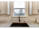 Kitchen sink with a modern faucet and window overlooking a wooded area at 14415 Autumncrest Rd # 2, Huntersville, NC 28078