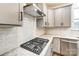 Modern kitchen features gas cooktop, stainless steel appliances, and white subway tile backsplash at 14415 Autumncrest Rd # 2, Huntersville, NC 28078