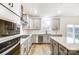 Kitchen with gray cabinets, granite countertops, stainless steel appliances, and deck access at 14415 Autumncrest Rd # 2, Huntersville, NC 28078