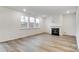 Living room with hardwood floors, fireplace, and large windows at 14415 Autumncrest Rd # 2, Huntersville, NC 28078