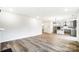Open concept living area with hardwood floors and a view into the kitchen at 14415 Autumncrest Rd # 2, Huntersville, NC 28078