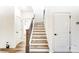 Wooden staircase with black metal railing leading to upper level at 14415 Autumncrest Rd # 2, Huntersville, NC 28078