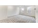 Bright bedroom featuring gray carpeting and large windows at 14421 Autumncrest Rd # 3, Huntersville, NC 28078