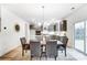 Bright dining area with gray chairs, a modern chandelier, and sliding door access to a deck at 14421 Autumncrest Rd # 3, Huntersville, NC 28078
