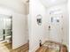 Light and airy entryway with hardwood floors and access to a full bathroom at 14421 Autumncrest Rd # 3, Huntersville, NC 28078