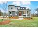 Two-story home with gray siding, stone accents, and a covered front porch at 14421 Autumncrest Rd # 3, Huntersville, NC 28078