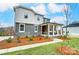 Two-story house with gray siding, stone accents, and a landscaped yard at 14421 Autumncrest Rd # 3, Huntersville, NC 28078