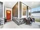 Inviting front porch with stone base and comfortable wicker chairs at 14421 Autumncrest Rd # 3, Huntersville, NC 28078