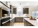 Modern kitchen with gray cabinets, quartz countertops, and stainless steel appliances at 14421 Autumncrest Rd # 3, Huntersville, NC 28078