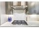 Modern gas cooktop with stainless steel vent hood and white quartz countertop at 14421 Autumncrest Rd # 3, Huntersville, NC 28078