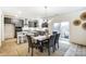 Modern kitchen with gray cabinets, a large island, and stainless steel appliances at 14421 Autumncrest Rd # 3, Huntersville, NC 28078