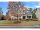 Two story house with brown siding and a manicured lawn at 16803 Rudence Ct, Charlotte, NC 28278