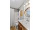 Bathroom with tub, wooden vanity, and white subway tile at 169 Rimmer Farm Rd, Troutman, NC 28166