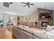 Open floor plan with a stone fireplace, hardwood floors, and views into the dining area and kitchen at 169 Rimmer Farm Rd, Troutman, NC 28166