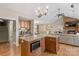Open kitchen with granite island, stainless steel appliances, and views into the living room at 169 Rimmer Farm Rd, Troutman, NC 28166