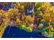 Aerial view of home on a wooded lot, near a pond at 169 Rimmer Farm Rd, Troutman, NC 28166