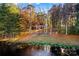 House nestled on a waterfront lot with autumn foliage at 169 Rimmer Farm Rd, Troutman, NC 28166