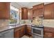 Kitchen features granite countertops, wood cabinets, and a window overlooking the backyard at 169 Rimmer Farm Rd, Troutman, NC 28166