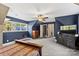 Blue-walled bedroom with two windows and a ceiling fan at 169 Rimmer Farm Rd, Troutman, NC 28166