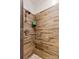 Modern shower with wood-look tile and pebble floor at 169 Rimmer Farm Rd, Troutman, NC 28166