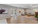 Finished basement with L-shaped couch and access to patio at 169 Rimmer Farm Rd, Troutman, NC 28166