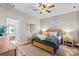 Cozy bedroom with wood flooring, large windows, ceiling fan, and ensuite bathroom access at 169 Rimmer Farm Rd, Troutman, NC 28166