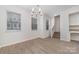 Light-filled dining area with hardwood floors and a modern chandelier at 2304 Via Dei Conte Aly, Charlotte, NC 28205