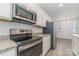 Stainless steel appliances and granite countertops in this modern kitchen at 2304 Via Dei Conte Aly, Charlotte, NC 28205