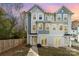 Three-story townhome with gray siding and a charming front porch at 2304 Via Dei Conte Aly, Charlotte, NC 28205