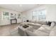 Living room with large sectional sofa, wood flooring, and ample natural light at 2304 Via Dei Conte Aly, Charlotte, NC 28205