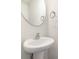 Modern bathroom with pedestal sink and oval mirror at 2304 Via Dei Conte Aly, Charlotte, NC 28205