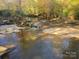 Tranquil creek flowing through wooded area at 2818 Rockford Rd, Shelby, NC 28152