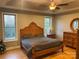 Bright bedroom with a wooden bed frame and large windows at 2818 Rockford Rd, Shelby, NC 28152