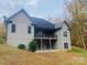 Home's back elevation, showcasing a deck and wooded area at 2818 Rockford Rd, Shelby, NC 28152