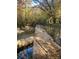 Serene creek with a stone dam and autumn foliage at 2818 Rockford Rd, Shelby, NC 28152