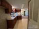 View of kitchen with wood cabinets and access to another room at 299 Stikeleather Rd, Hiddenite, NC 28636