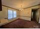 Bright dining room with a chandelier and carpet flooring at 299 Stikeleather Rd, Hiddenite, NC 28636