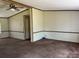 Spacious living room with carpet and wood trim at 299 Stikeleather Rd, Hiddenite, NC 28636