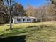 Single-story house with yard and wooded backdrop at 299 Stikeleather Rd, Hiddenite, NC 28636