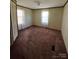 Simple bedroom with carpet flooring and two windows at 299 Stikeleather Rd, Hiddenite, NC 28636