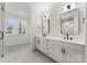 Elegant bathroom with double vanity, large mirror, and tile flooring at 3013 Fairview Townes Ct, Charlotte, NC 28210