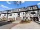 Three-unit townhome building, white brick exterior, gray roofs, and attached garages at 3013 Fairview Townes Ct, Charlotte, NC 28210